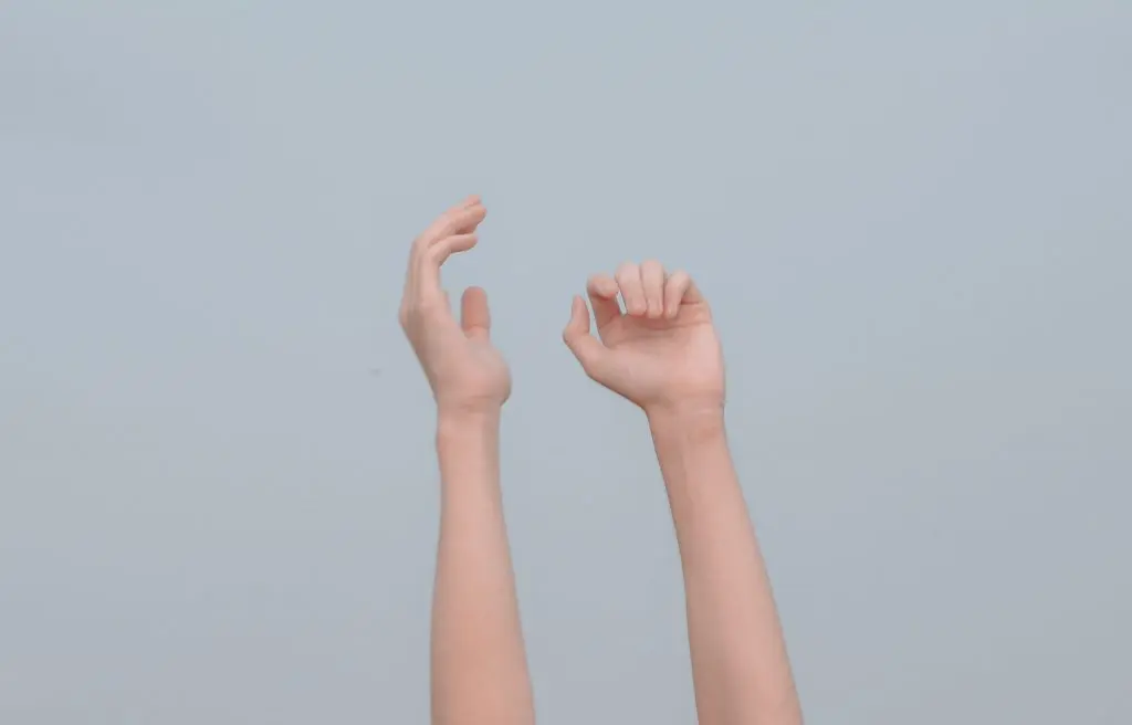 image of hands reaching to the sky